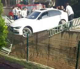 Korkuluklarda asılı kalan otomobile vatandaşlar yetişti
